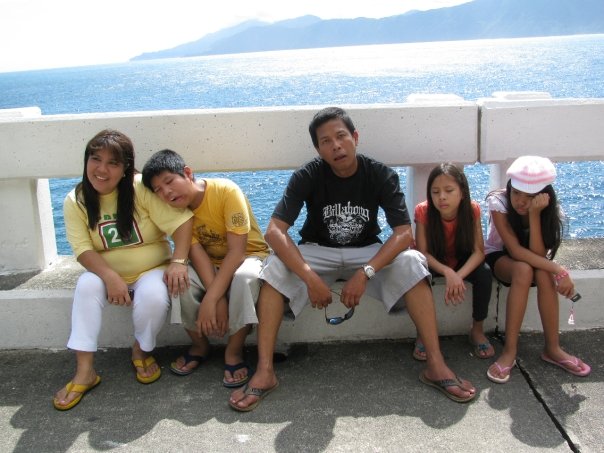 family sitting by the bay